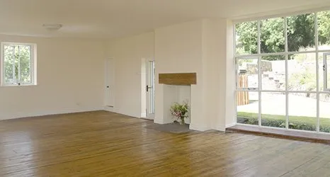 Empty house with cream walls and fireplace with no fire